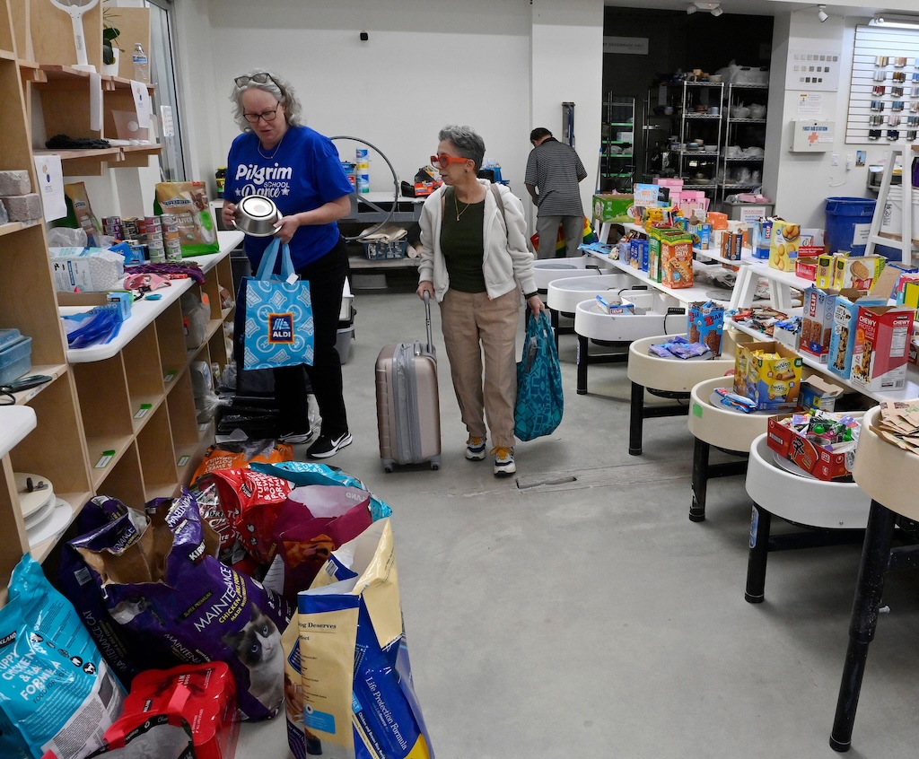 Evacuated residents by the Eaton wildfire finding supplies and aid at a donation center in Altadena, California.