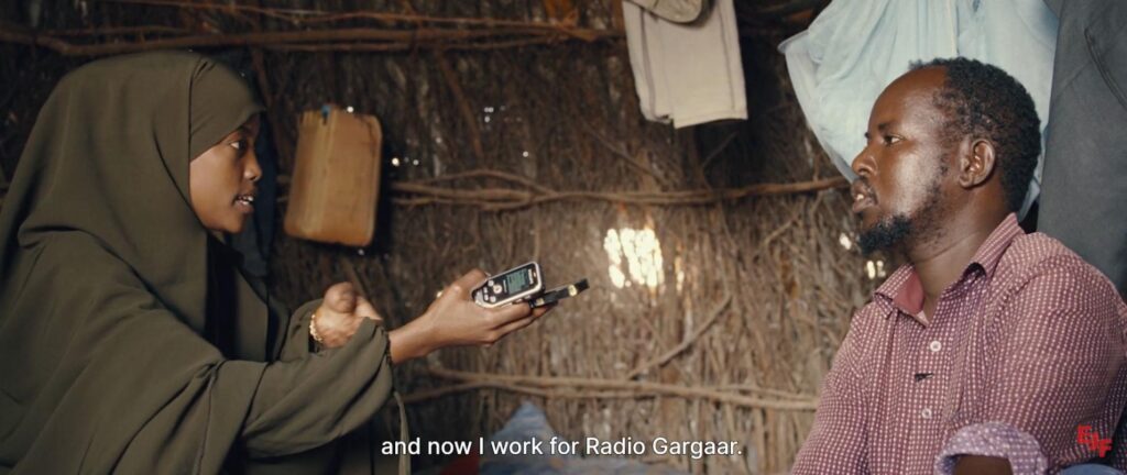 Still from Radio Dadaab film with quote saying "and now I work for Radio Gargaar"