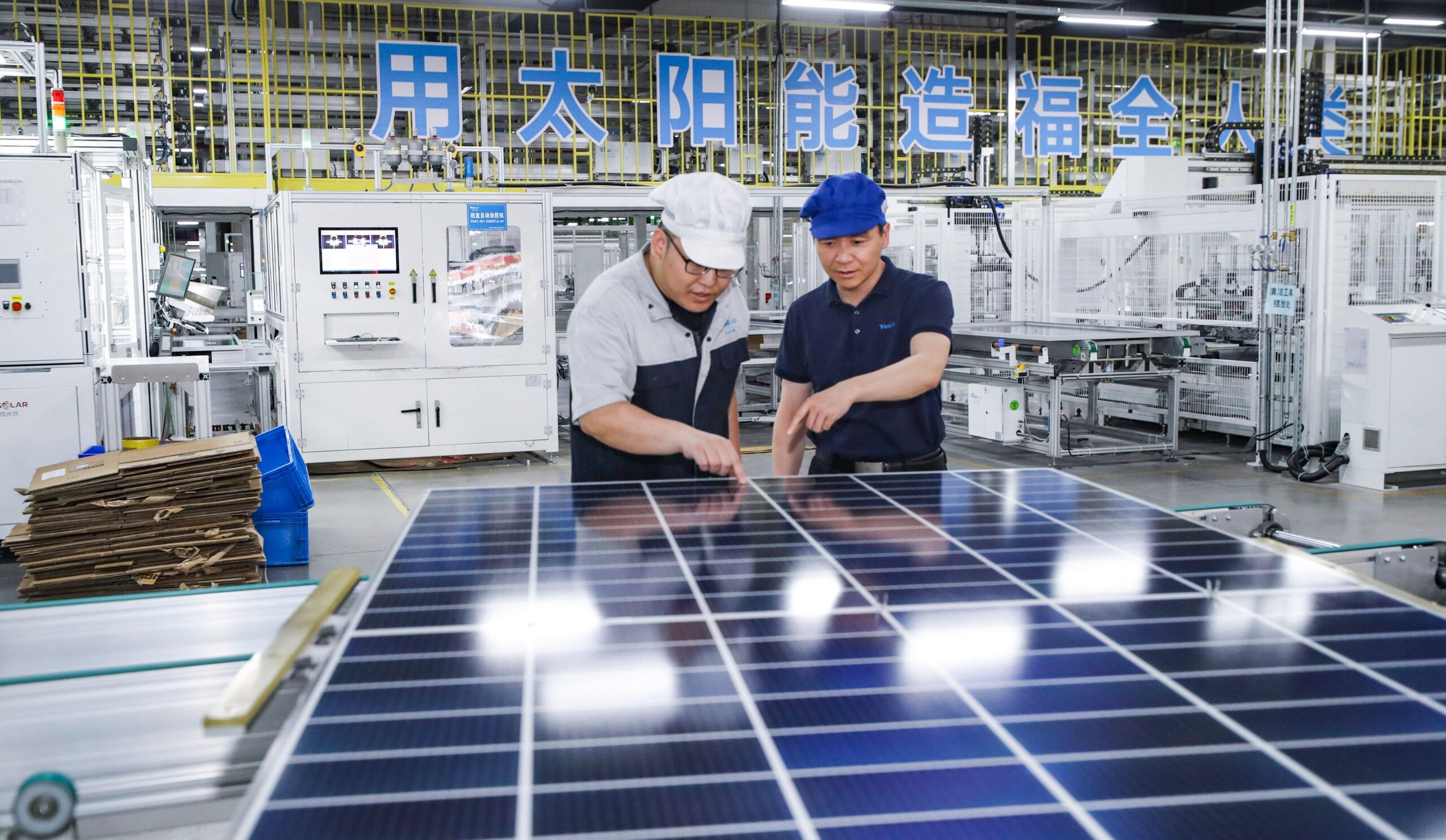 Workers at a photovoltaic panel workshop in Jiangsu province, China. 