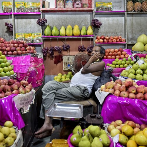 A fruit seller sleeps in his fruit shop in Kolkata, India.